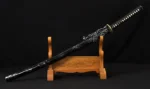 amascus folded steel katana displayed on wooden stand