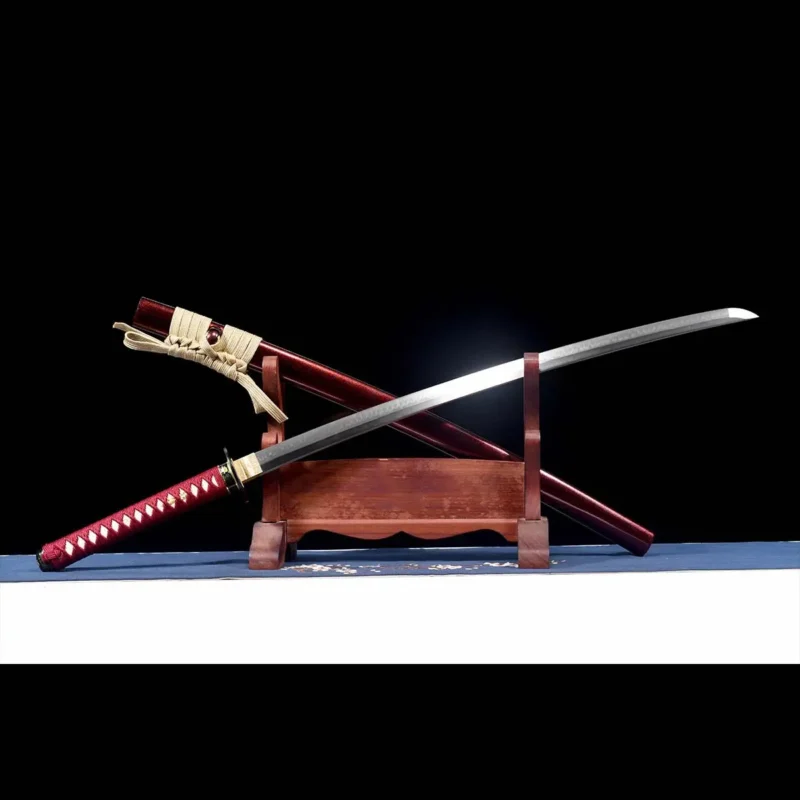 T10 katana on display stand showing full tang construction black openwork chrysanthemum guard