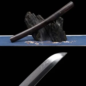 15 T10 Clay Tempered Tanto Sword Ebony Saya Sheathed on Rock Stand with Hamon Blade Close-up — Aikuchi Japanese Short Sword